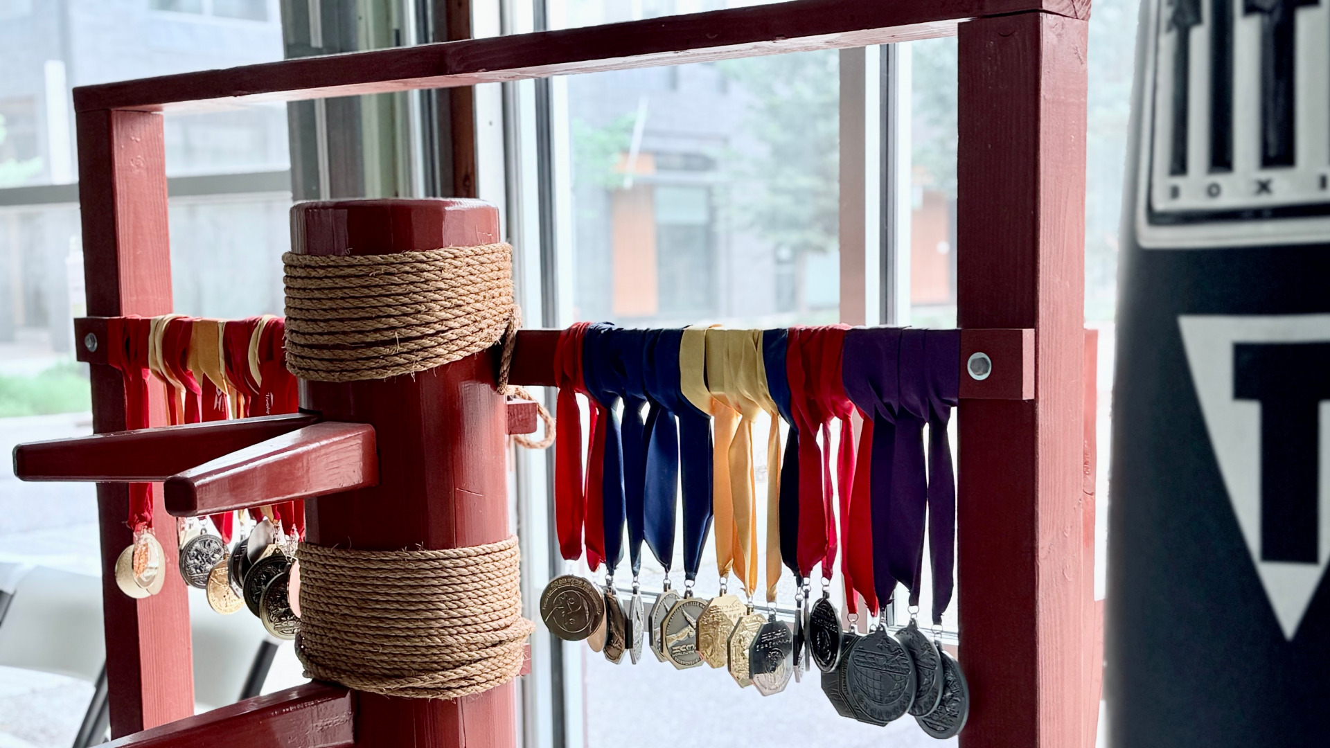 Wooden training dummy and medals at Boulder Kung Fu Academy